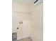 Well-lit laundry room features tiled floors and hookups for a washer and dryer and a wire shelf above at 7924 Carriage Pointe Dr, Gibsonton, FL 33534