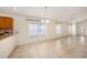 Open living room with tile flooring, a ceiling fan, and a chandelier over the dining area at 7924 Carriage Pointe Dr, Gibsonton, FL 33534