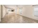 Spacious living room with tile flooring, large windows, and access to the kitchen at 7924 Carriage Pointe Dr, Gibsonton, FL 33534