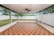 A spacious screened patio featuring a ceiling fan and a decorative tiled floor provides a great outdoor living space at 7924 Carriage Pointe Dr, Gibsonton, FL 33534