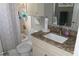 Well-lit bathroom with granite countertop vanity, tub shower, and neutral color palette at 8609 Thimbleberry Ln, Tampa, FL 33635