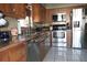 Functional kitchen featuring granite counters, stainless steel appliances, and tiled backsplash at 8609 Thimbleberry Ln, Tampa, FL 33635