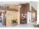 Spacious living room featuring a fireplace, ceiling fan, and seamless access to an adjacent kitchen at 8609 Thimbleberry Ln, Tampa, FL 33635