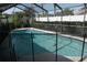 Relaxing screened-in pool area surrounded by a fence, offering privacy and an inviting outdoor space at 8609 Thimbleberry Ln, Tampa, FL 33635
