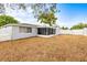 Large fenced yard with a screened-in porch offers privacy and space for outdoor activities at 9216 Mark Twain Ln, Port Richey, FL 34668