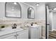 Bright bathroom featuring double vanity sinks, modern fixtures and decor and attractive accent wall at 9216 Mark Twain Ln, Port Richey, FL 34668