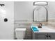 Cozy bathroom featuring modern fixtures, accent wall, and a shower at 9216 Mark Twain Ln, Port Richey, FL 34668