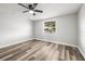 Bedroom featuring new floors, fresh paint, a ceiling fan, and a large window to let in lots of light at 9216 Mark Twain Ln, Port Richey, FL 34668