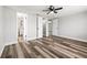 Bedroom with stylish floors, fan, and multiple doorways at 9216 Mark Twain Ln, Port Richey, FL 34668