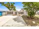 Charming single-story home featuring a cozy front yard, wood shutters, and blue front door at 9216 Mark Twain Ln, Port Richey, FL 34668