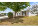 Charming home with manicured lawn and mature trees offering great curb appeal and a welcoming ambiance at 9216 Mark Twain Ln, Port Richey, FL 34668