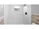 Tiled shower featuring a showerhead and window at 9216 Mark Twain Ln, Port Richey, FL 34668