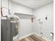 Utility room with a water heater, shelving, and washer/dryer hookups at 9216 Mark Twain Ln, Port Richey, FL 34668