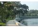 Picturesque waterfront park setting with walking path and tranquil water views near property at 9216 Mark Twain Ln, Port Richey, FL 34668