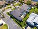 An elevated aerial view highlighting a private pool, screened in patio, and lush landscaping at 1002 Romano Ne Ct, St Petersburg, FL 33702
