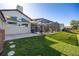 Expansive backyard with a screened-in patio, lush green lawn, and mature trees creating a private oasis at 1002 Romano Ne Ct, St Petersburg, FL 33702