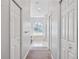 Hallway view of the spacious bathroom featuring a tub, and neutral decor at 1002 Romano Ne Ct, St Petersburg, FL 33702