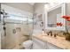 Bathroom features a glass door shower with tile surround, granite counters, and modern fixtures at 1002 Romano Ne Ct, St Petersburg, FL 33702