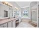 Bathroom with double sinks, a soaking tub, and a separate shower at 1002 Romano Ne Ct, St Petersburg, FL 33702