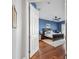 Cozy bedroom featuring hardwood floors, soft carpet, and an accent wall at 1002 Romano Ne Ct, St Petersburg, FL 33702