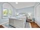 Comfortable bedroom with wood floors, plantation shutters, and a large bed with floral bedding at 1002 Romano Ne Ct, St Petersburg, FL 33702