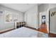 Bright bedroom features hardwood floors, neutral walls, large closet, and natural light from the window with shutters at 1002 Romano Ne Ct, St Petersburg, FL 33702