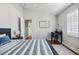 Inviting bedroom featuring hardwood floors, a desk, and a closet, bathed in natural light at 1002 Romano Ne Ct, St Petersburg, FL 33702