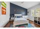 Charming bedroom with hardwood floors, a ceiling fan, and custom wall decor at 1002 Romano Ne Ct, St Petersburg, FL 33702
