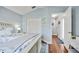 Cozy bedroom features wood floors, blue walls, closet, and a large bed with floral bedding at 1002 Romano Ne Ct, St Petersburg, FL 33702