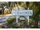 A decorative sign welcomes you to the Isle of Caya Costa, with lush greenery and a peaceful setting at 1002 Romano Ne Ct, St Petersburg, FL 33702