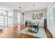 Bright dining room featuring wood floors, modern light fixture, and a dining table with seating for six at 1002 Romano Ne Ct, St Petersburg, FL 33702