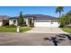 Beautiful single-story home boasting a well-manicured lawn, three car garage and dark metal roof at 1002 Romano Ne Ct, St Petersburg, FL 33702
