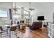 Open-concept living room with hardwood floors, fireplace, comfortable seating, and large windows at 1002 Romano Ne Ct, St Petersburg, FL 33702