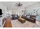 Open-concept living area with hardwood floors, vaulted ceilings, and seamless flow to the kitchen at 1002 Romano Ne Ct, St Petersburg, FL 33702
