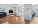 Spacious living room with wood floors, piano, TV, and large windows with plantation shutters at 1002 Romano Ne Ct, St Petersburg, FL 33702