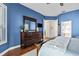 Main bedroom with hardwood floors, a dresser, and an open doorway to the Primary bath at 1002 Romano Ne Ct, St Petersburg, FL 33702