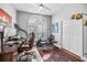 Bright office with a desk, workout equipment, and a large window with plantation shutters at 1002 Romano Ne Ct, St Petersburg, FL 33702