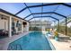 Inviting pool area featuring a screened enclosure, spacious deck, and outdoor seating area at 1002 Romano Ne Ct, St Petersburg, FL 33702
