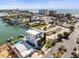 Aerial view of a modern two-story home with a balcony in a coastal community at 109 Punta Vista Dr, St Pete Beach, FL 33706