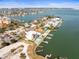 Aerial view of a modern two-story home with a pool in a waterfront community at 109 Punta Vista Dr, St Pete Beach, FL 33706