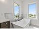 Bright bathroom featuring soaking tub with scenic views at 109 Punta Vista Dr, St Pete Beach, FL 33706