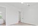 Well-lit bedroom featuring hardwood floors and a doorway to the en-suite bathroom at 109 Punta Vista Dr, St Pete Beach, FL 33706