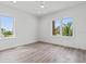 Bright, airy bedroom with hardwood floors and natural light from two large windows at 109 Punta Vista Dr, St Pete Beach, FL 33706