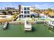 Beautiful waterfront three-story home featuring a private dock, boat lift, swimming pool, and meticulously manicured landscaping at 109 Punta Vista Dr, St Pete Beach, FL 33706