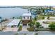 Beautiful waterfront home with lush landscaping, a modern exterior, and a spacious driveway at 109 Punta Vista Dr, St Pete Beach, FL 33706