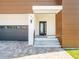 Stunning modern home featuring a welcoming front entrance, contemporary design elements, and a stylish garage door at 109 Punta Vista Dr, St Pete Beach, FL 33706