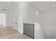 Hallway with hardwood floors, white walls, and modern staircase at 109 Punta Vista Dr, St Pete Beach, FL 33706