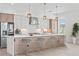 Modern kitchen featuring an island with bar stool seating, stainless steel appliances, and stylish pendant lighting at 109 Punta Vista Dr, St Pete Beach, FL 33706