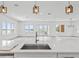 Open-concept living space with water views, bright lighting, and a large island with sink at 109 Punta Vista Dr, St Pete Beach, FL 33706