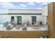Stylish roof deck with comfortable seating, dining area, and views of the surrounding neighborhood and water at 109 Punta Vista Dr, St Pete Beach, FL 33706